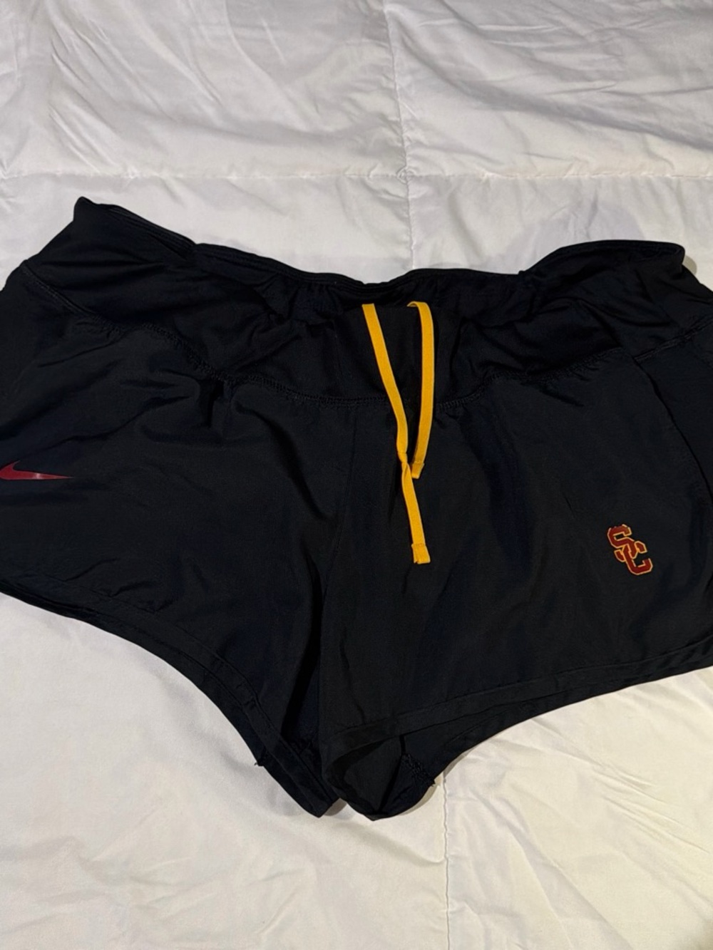 Nike Black Athletic Shorts with Gold Drawstring and Red Accents